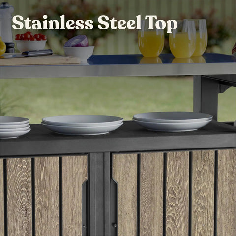 Wood Look Outdoor Entertainment Cart With 78 Gallon Storage, Stainless Steel Top For BBQ Prep, Weather Resistant Resin, Patio Deck Backyard Party Station, DecoCoat Finish In Ashwood showing plates and drinks.