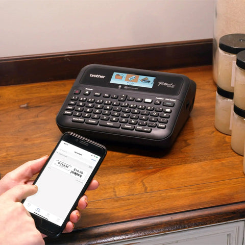 Person using P Touch PT D610BT Label Maker with Bluetooth and USB Pro Grade Connected Label Printer at home office
