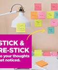 Super Sticky Notes 3 By 3 Inches Supernova Neons 24 Pack on a desk with a lamp, vibrant colors used as reminders.