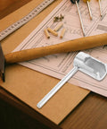 Heavy Duty Universal Fire Sprinkler Wrench Tool Rock Solid Metal Spanner on a workbench with a hammer and tools.