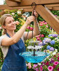 Woman hanging Solar Bird Bath Fountain With Hanging Cascade Water Bowl And Pump Outdoor Garden Decor For Hummingbirds Easy Sun Powered Water Feature That Runs On Direct Sunlight No Batteries Needed Blue
