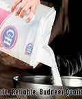 Hassle Free Eight Quart Clear Food Storage Bin With Slick Pour Spout And Grippy Handle pouring sugar into a bowl.