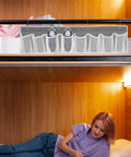 Compact Mesh Shoe Storage Hangs Beside Bed With 4 Hooks For RV Camper And Home To Stash Sneakers And Boots While Keeping Floors Tidy, gray fabric with shoes organized in mesh pockets.