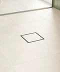 Square Tileable Shower Drain Set With Brushed Stainless Steel Construction And Flush Floor Mount Design For Modern Bathrooms, installed in tiled shower floor.