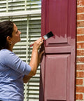 Woman applying paint to a vinyl shutter while using Bring Outdoor Gear Back To Life With This Ultimate Restorer And Cleaner Combo That Wipes Out Fading.