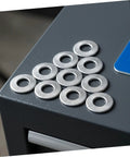 Built Different M6 Stainless Steel Belleville Washers 40 Piece Conical Spring Lock Plate Assembly on a gray surface.