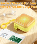 Lens-wipe carrying case: yellow square tin with orange slice lid, zipper and clip, shown with glasses.