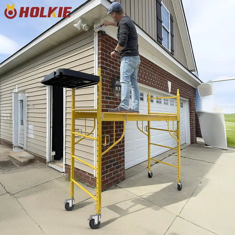 Man standing on scaffold with 5 Inch Scaffolding Caster Wheels Set Of Four With Dual Locking Swivel Casters And One And A Quarter Inch Square Stem For Stainless Steel Scaffold Tubes Heavy Duty Replacement Castors 1190 Lb Load Capacity Industrial Grade