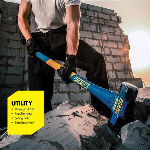 Person using Hard Face 16 Pound Sledge Hammer For Demolition And Stake Driving With 36 Inch Fiberglass Handle Induction Hardened To 50 55 HRC Overstrike Protection And Textured Grip for demolition on a stone wall.
