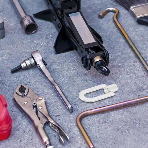 Close-up of Three Piece Auto Dent Puller Rings Kit Aluminum Welding Dent Puller Tool Set with various tools on concrete