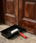 Slick Mini Paint Roller Kit With Built In Tray For Precision Detail Work, featuring a mini roller and tray against wooden door.