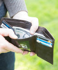 Trifold Leather Wallet For Men With RFID Blocking Napa Leather 9 Card Slots ID Window Divided Billfold Slim Durable Everyday Carry EDC Ready Quality Brown shown open with cash and cards.