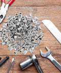 Flat Head Knurled Rivet Nuts Kit Stainless Steel 120 Piece Set Threaded Rivets on a wooden surface with tools