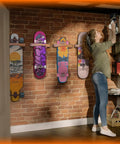 Premium Wooden Vertical Skateboard Wall Mount Rack And Heavy Duty Storage Hanger For Standard Decks adding style to a brick wall.