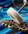 Close-up of No Doubt A Super Clean Mini Nylon Polish Brush Set polishing a brass decorative piece with a rotary tool.