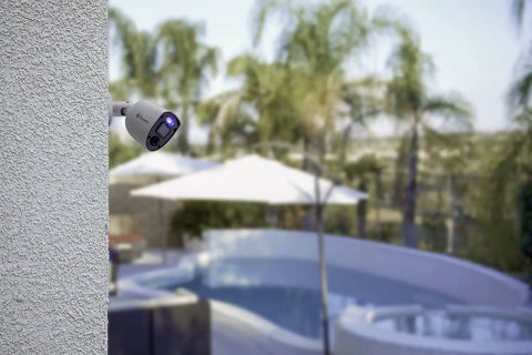 Add On 4K Security Bullet Cam With Flashing Lights And Sensor Spotlight For Indoor Or Outdoor Use, attached to a wall over pool area