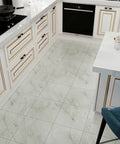 Wood Look Peel And Stick Vinyl Tiles 12x12 Inches, 24 Pack, in a kitchen setting with white cabinets and gray distressed planks