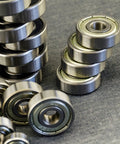 Tough As Nails 6901ZZ Deep Groove Ball Bearings With Dual Metal Shields High Speed Carbon Steel Construction 12mm Inside 24mm Outside By 6mm Pack Of Ten stacked and arranged on a gray surface.