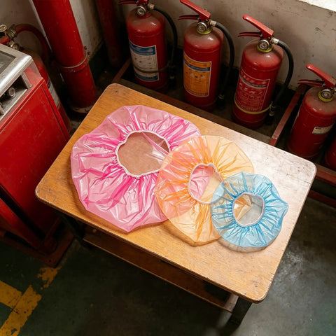 Universal Fire Alarm Covers 96 Pack Elastic Smoke Detector Caps in pink, orange, and blue on a wooden table.