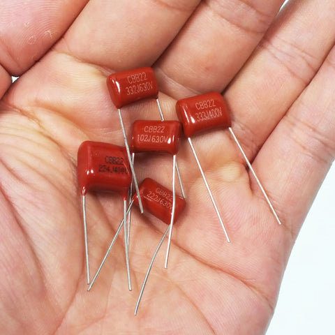 Premium Metallized Polypropylene Film DC Capacitor Kit With Hella Versatile CBB22 Assortment in hand showing various values.