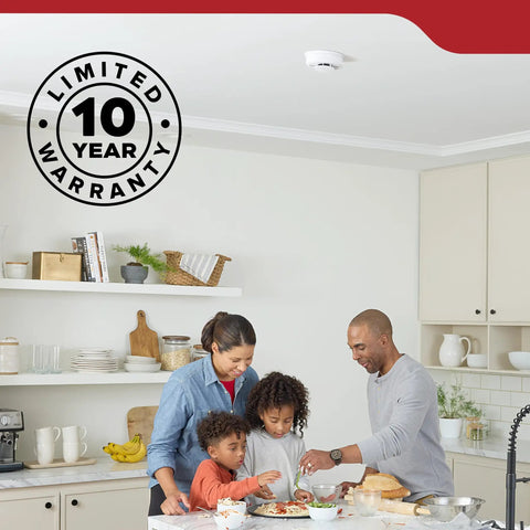 Family cooking in a modern kitchen with Rock Solid Hardwired Smoke Detectors With AA Battery Backup And Interconnectable Wiring.