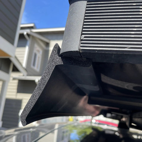 Close-up of Premium Flexible Wind Deflector Fairing for Roof Rack Crossbars, foam rubber material, showing attachment detail.