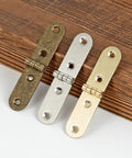 Forty Piece Gold Brass Mini Hinges With Matching Screws Offering No Sweat Installation And Fade Proof Finish Perfect For Tiny Drawers Birdhouses And All Your Weekend Warrior Maker Projects displayed in three colors on wood surface.