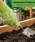 Green floral non-slip gloves holding a trowel in garden, part of the Two Pack Pruning Shears For Garden Work set.