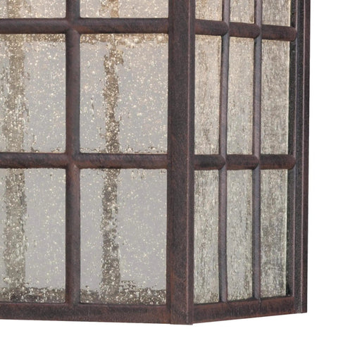 Solid Exterior Wall Lantern Featuring Slick Weathered Patina Cast Aluminum Body Plus Crisp Seeded Glass Panes close-up view of seeded glass texture.