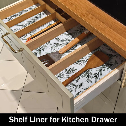 Top Shelf Non Adhesive Shelf Liners For Pantries Drawers And Closets With Nonslip Texture Durable Material Easy To Trim And Slide Into Place Every Single Time No Fuss Home Setup Game Changer in a kitchen drawer with wooden utensils on patterned liner.
