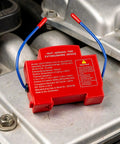 Aerosol Fire Extinguisher for Cars Automatic Self Adhesive Peel and Stick Vehicle Safety Gear close-up on engine component.