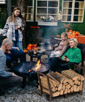 34 Inch Outdoor Indoor Firewood Rack With Bronze Finish near group enjoying outdoor firewood setup