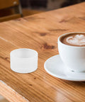 Compact Sturdy Coffee Pressing Adapter For Coffee Holder, Lightweight White PP Material, Pro Grade Precision Craftsmanship For Even Espresso Compression, No Fuss Portable Espresso Machine Accessory, Replacement Ring And Powder Holder Base beside latte