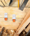 Rock Solid Wooden Door Bottom Pulleys Two Pack Anti Sag Bottom Caster Wheels gliding on wooden surface with tools nearby.