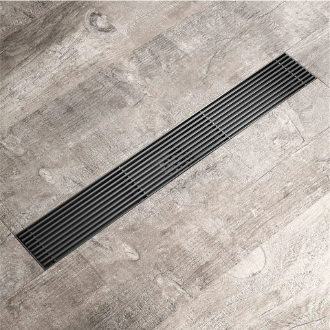 Smooth Flow Stainless Steel Linear Shower Drain With Removable Grate And Built In Hair Catcher Rock Solid Rectangle Floor Drain For Modern Bathrooms Dope Rose Gold Clog Free Design on textured floor.
