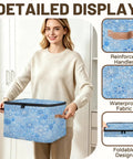 Heavy Duty Waterproof Polyester Storage Containers With A Slick Two Way Zipper Closure And Blue White Snowflake Design held by a person.