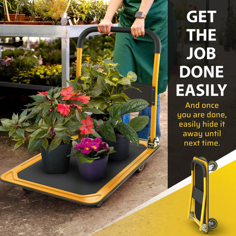 Person using Heavy Duty Foldable Push Cart Dolly With 660 Lb Capacity in a garden setting with plants, folded view shown.