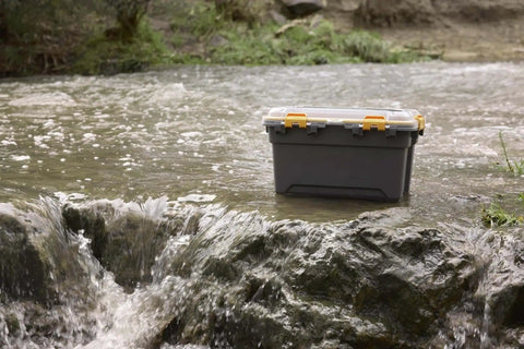 Toss Your Gear In This Heavy Duty 5.28 Gallon Waterproof Plastic Storage Tote Bin featuring a weather tight seal on wet ground.