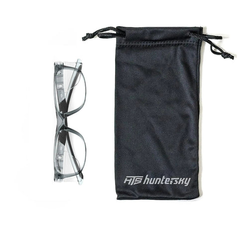 Hella Rugged Z87 Safety Glasses With Side Shields Anti Scratch Fog Resistant Lens beside a black storage pouch.