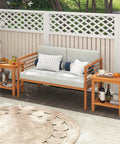 Acacia Wood Outdoor Side Table With Slatted Top And Two Tier Storage Shelf For Backyard Poolside Patio Or Indoor Use Built To Last In Natural Finish No Fuss Durability beside a sofa outdoors