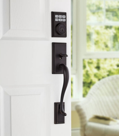 SmartCode Electronic Door Deadbolt 99090-023 with Smart Key Venetian Bronze Finish keyless entry on white door with keypad