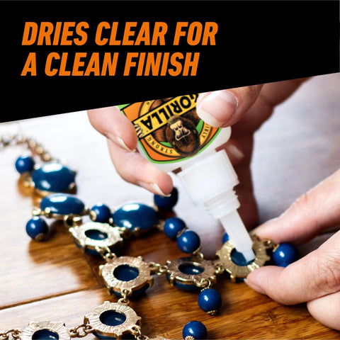 Gel Glue XL Clear Quick Bonding For All Purpose Repairs And Projects On Glass Plastic Wood Metal Ceramic Rubber Leather And More Thick No Run Formula For Vertical Surfaces 25 Gram Pack Of 1 being applied to a beaded necklace on a wooden surface.