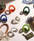 Set of Six Playful Ceramic Wall Hooks for Coats and Keys Game Changer Storage Solution Sweet Decorative Hangers Assorted Colors on table