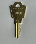 Close-up of a gold finish brass key, part of the Secure Your Workspace With These Top Shelf Replacement Keys For File Cabinets Two Piece Set.