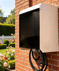 Hella Durable Heavy Duty EV Charger Weatherproof Shell featuring magnetic flip door mounted on a brick wall outdoors.