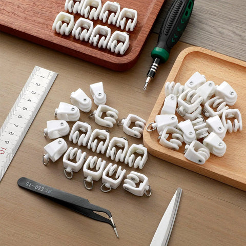 50 Piece Bulk Pack White Curtain Track Rollers Premium Quality Smooth As Butter Slick Glide Compatible With 11 mm Flexible Tracks on a wood surface.