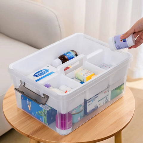 17 Quart Clear Plastic Storage Bins With Four Compartment Removable Tray filled with medicines, placed on a table