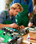 Men working on circuit boards using tools and electrolytic capacitors, part of Knockout 120 Piece Electrolytic Capacitor Assortment Kit.