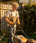 Rugged Mowing Goggles Featuring Anti Fog Coating And Tight Windproof Seals Keep Your Peepers Protected Against Grass Scrapes And Fine Dust While Trimming Land Or Running The Leaf Blower All Day worn by person mowing lawn.
