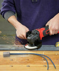 Person using a power angle grinder with sparks flying, showcasing the Compact Soft Start Module For Angle Grinders Smooth Power Ramp Up Kills Sudden Jerks While Shielding Main Breakers During Heavy Duty Tool Upgrades And All Day Grind Work Sessions.